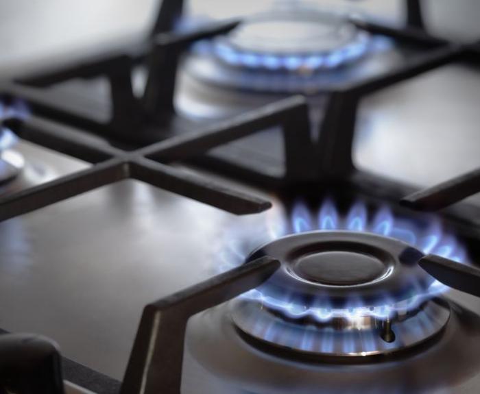 Image of gas stove with the burners on